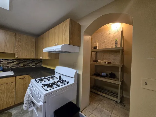 a kitchen with a stove and a cabinet