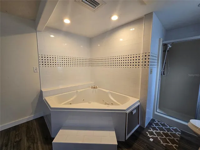 a bathroom with a tub and a shower