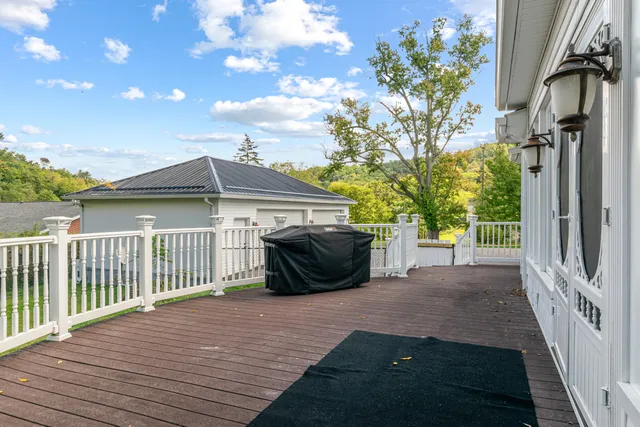 a view of a balcony with chairs and wooden floor