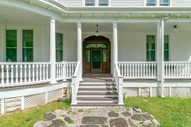 a view of a a dining room with furniture window and wooden floor