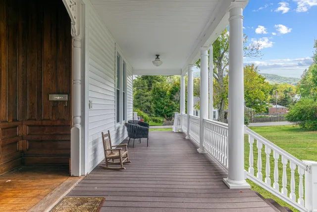 a view of a dining room with furniture wooden floor and chandelier