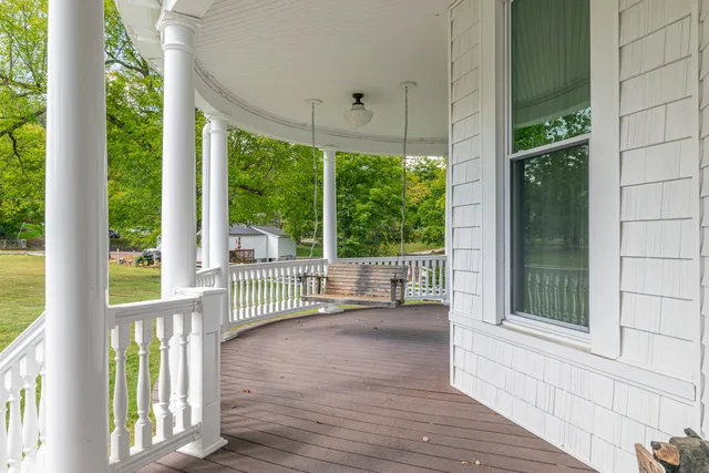 a kitchen with stainless steel appliances granite countertop a refrigerator a sink dishwasher a stove and a refrigerator with wooden floor