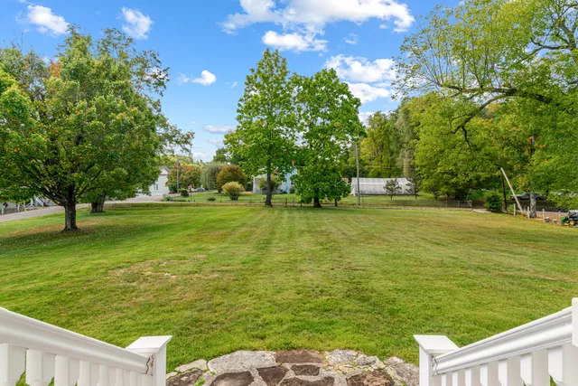 a kitchen with stainless steel appliances granite countertop a refrigerator and a wooden floor