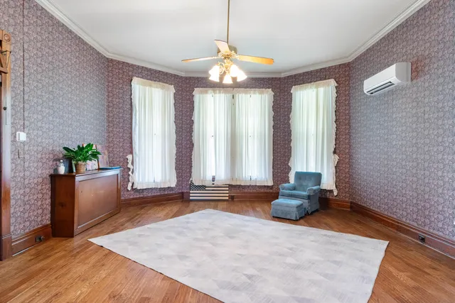 a spacious bedroom with a bed and a flat screen tv