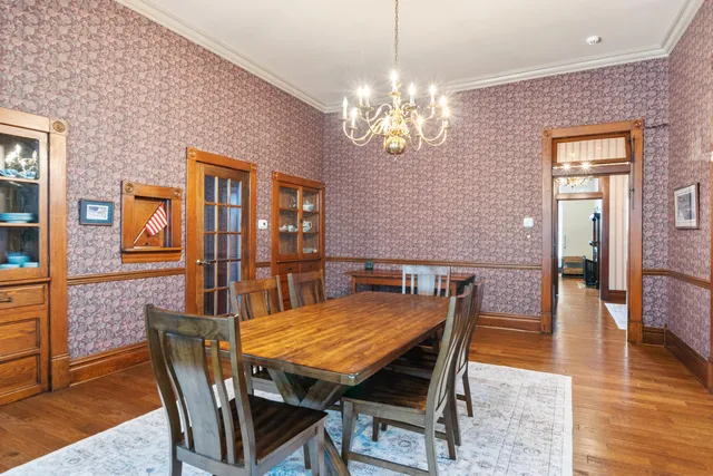 a living room with furniture a flat screen tv and floor to ceiling windows