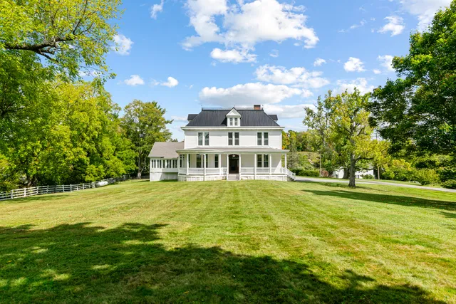 a front view of a house with a big yard