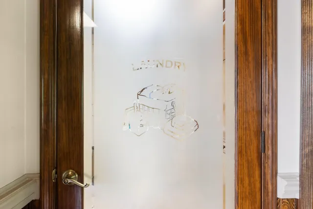 a view of a bedroom with a bed and a window