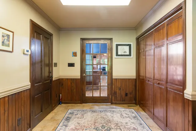 an aerial view of residential houses with outdoor space and ocean view