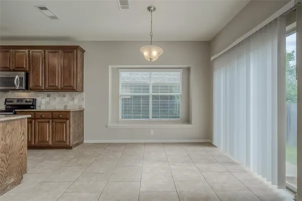 a view of an empty room with a kitchen