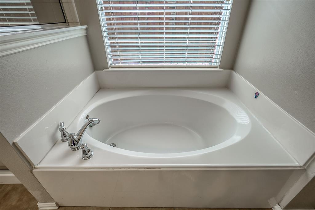 3100 Crossridge Drive McKinney, TX 75071 - Photo 22 of 40 a white bath tub sitting in a bathroom