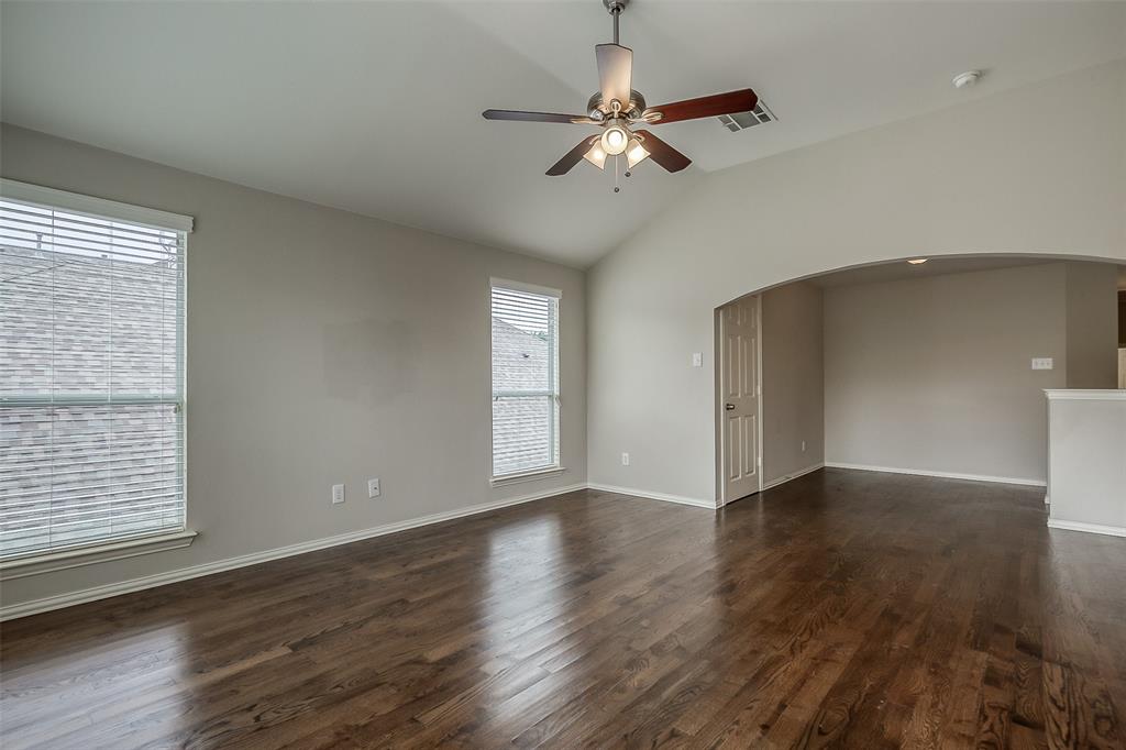 3100 Crossridge Drive McKinney, TX 75071 - Photo 24 of 40 an empty room with wooden floor fan and windows