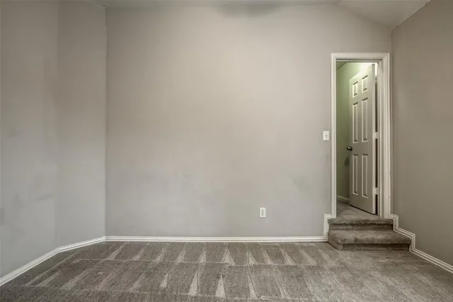 an empty room with chandelier fan