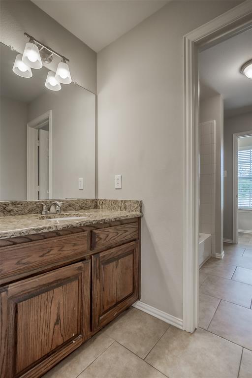 3100 Crossridge Drive McKinney, TX 75071 - Photo 28 of 40 a bathroom with a granite countertop sink and a mirror