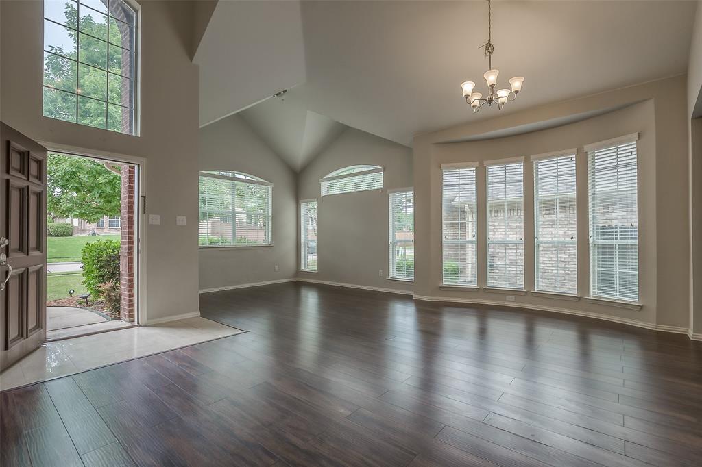 3100 Crossridge Drive McKinney, TX 75071 - Photo 3 of 40 a view of an empty room with wooden floor and a window