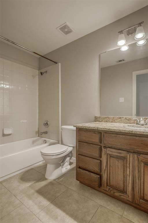 3100 Crossridge Drive McKinney, TX 75071 - Photo 34 of 40 a bathroom with a granite countertop toilet a sink and bathtub