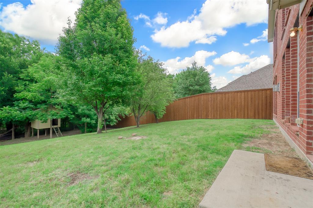 3100 Crossridge Drive McKinney, TX 75071 - Photo 36 of 40 a view of a backyard with table and chairs and wooden fence