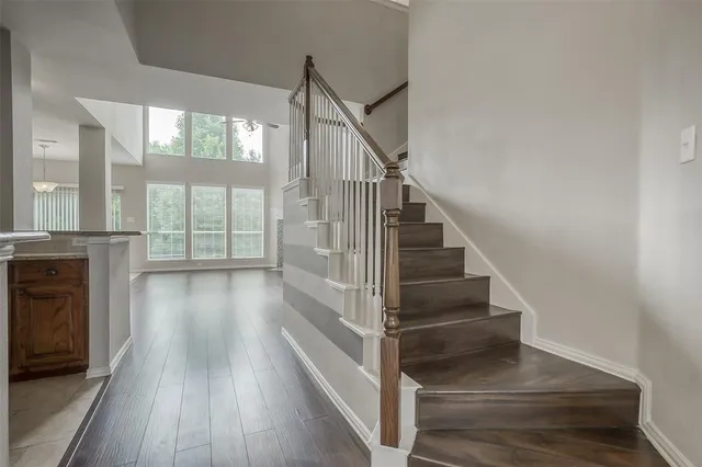 a view of entryway and hall with wooden floor