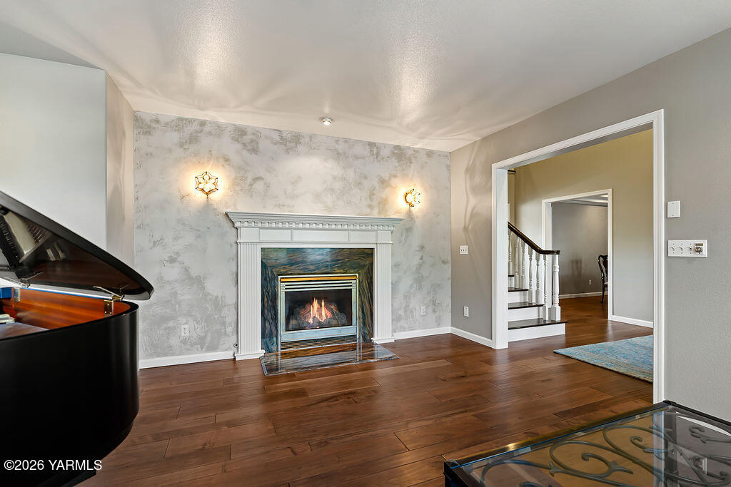 6810 Ravens Gate Way Yakima, WA 98908 - Photo 10 of 49 a view of a livingroom with wooden floor and a fireplace