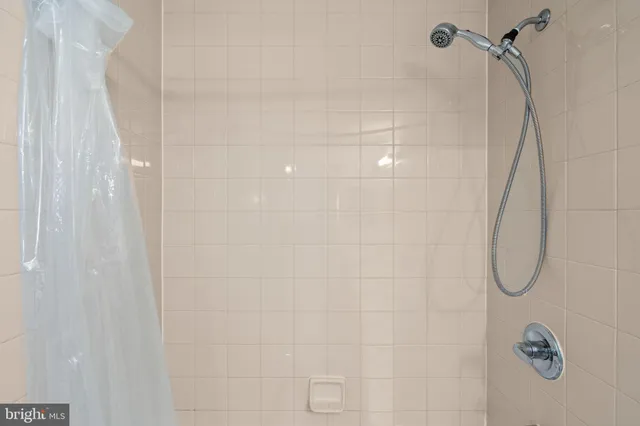 a bathroom with a sink toilet tub and shower
