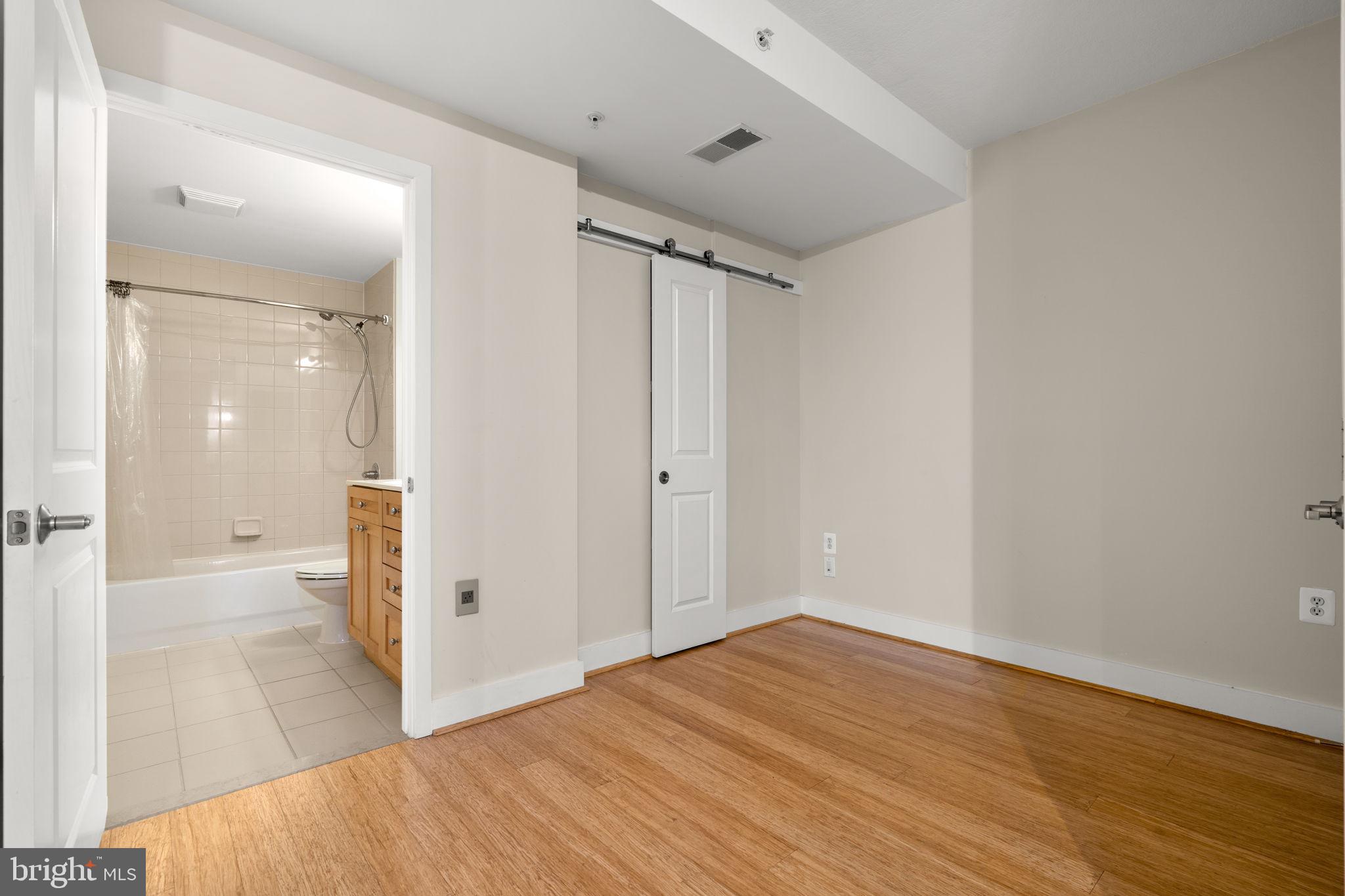 2001 15th Street North, Unit 813 Arlington, VA 22201 - Photo 18 of 31 wooden floor in an empty room