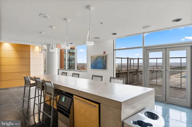 a dining hall with stainless steel appliances granite countertop a dining table and chairs