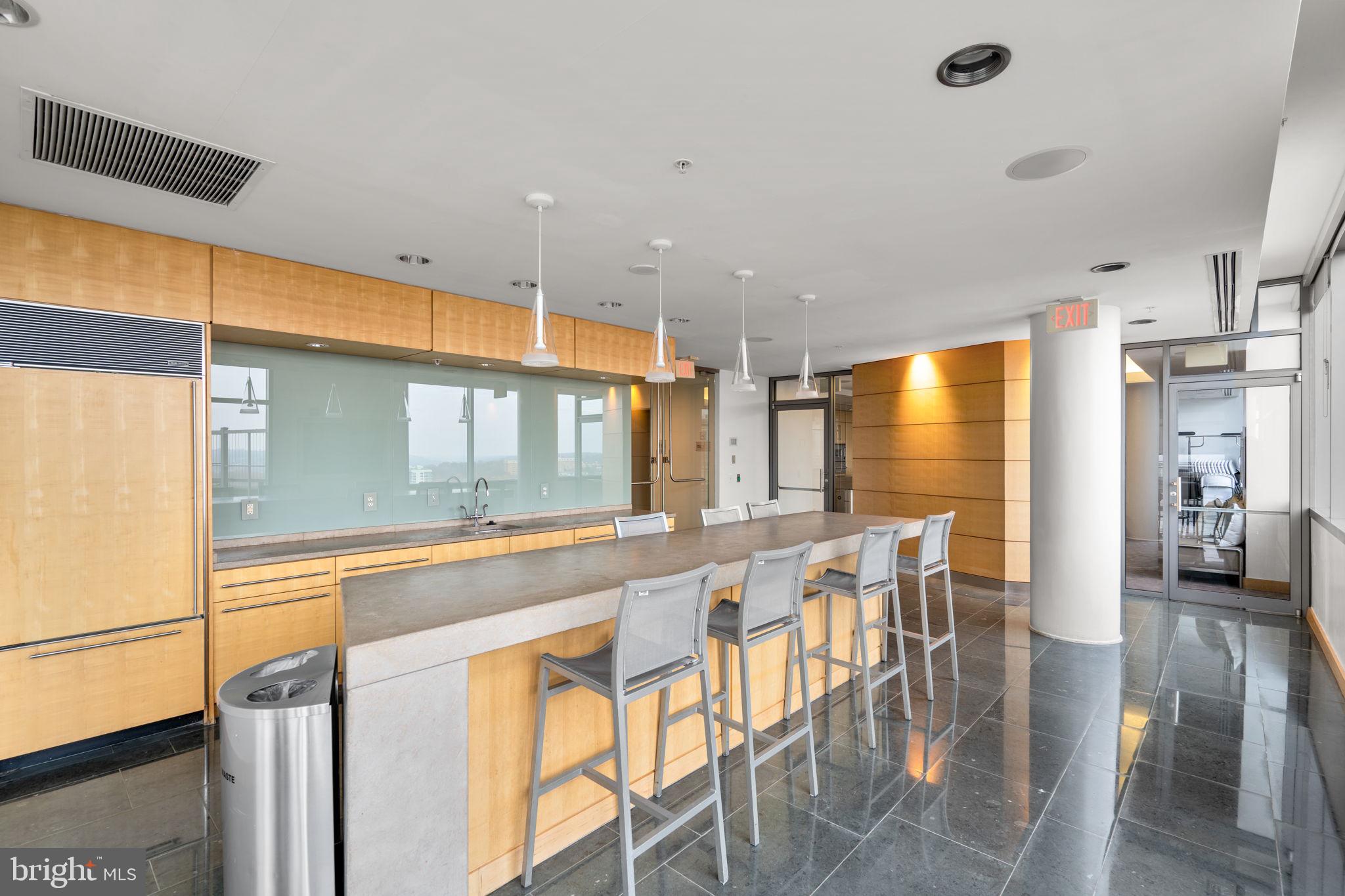 2001 15th Street North, Unit 813 Arlington, VA 22201 - Photo 22 of 31 a dining hall with stainless steel appliances granite countertop a dining table and chairs
