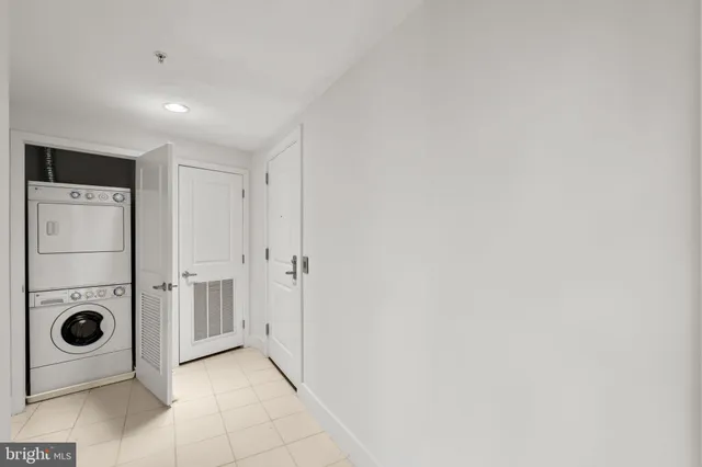 a view of a livingroom with a refrigerator and washer