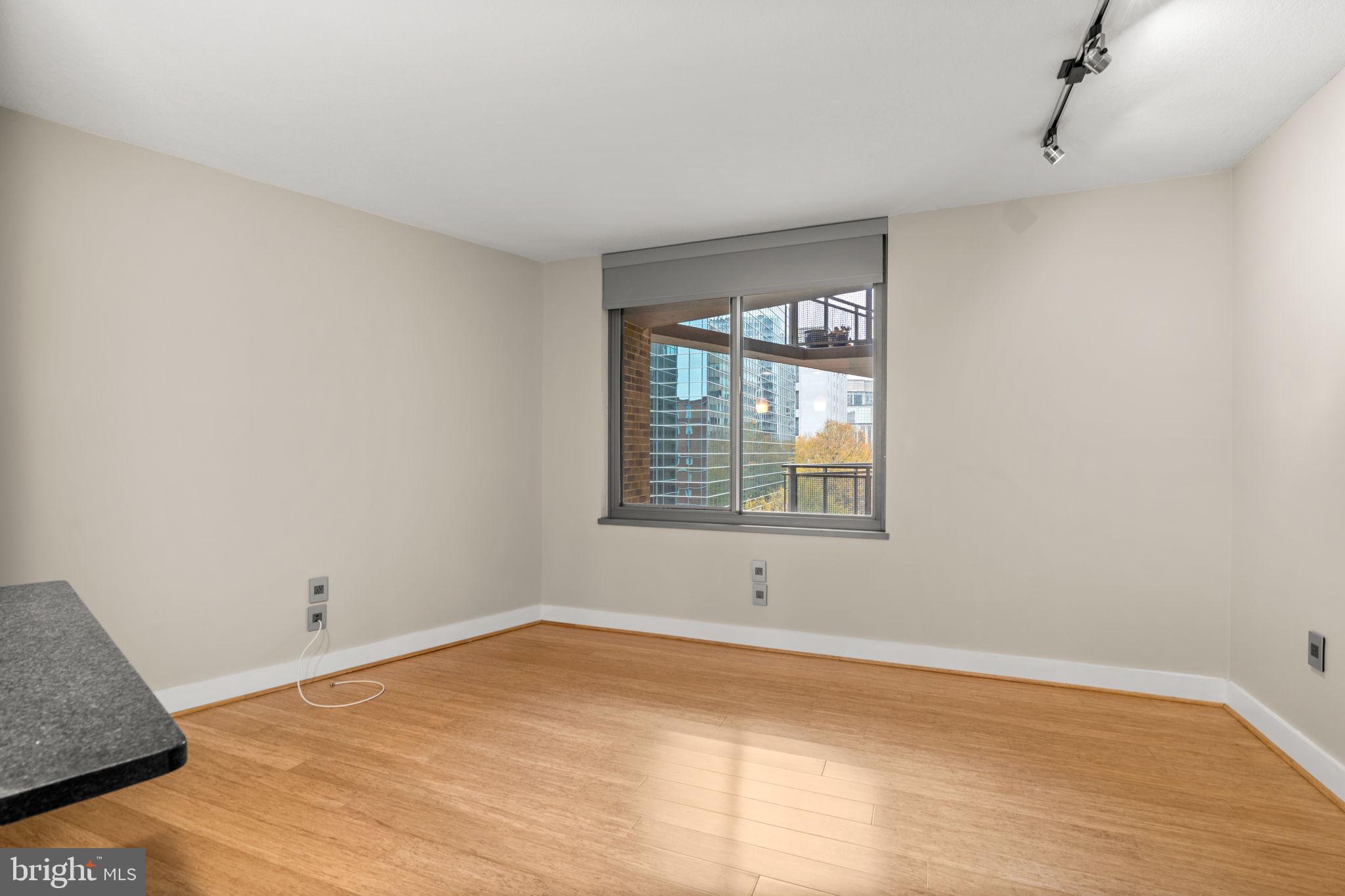 2001 15th Street North, Unit 813 Arlington, VA 22201 - Photo 5 of 31 a view of an empty room with wooden floor and a window