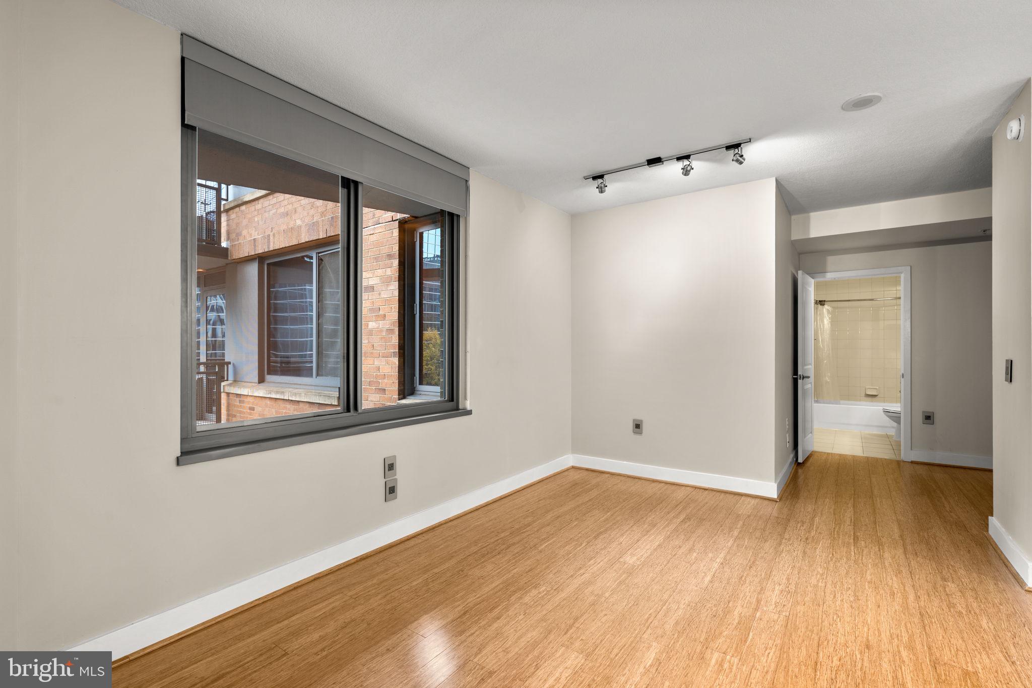 2001 15th Street North, Unit 813 Arlington, VA 22201 - Photo 8 of 31 a view of an empty room with wooden floor and a window