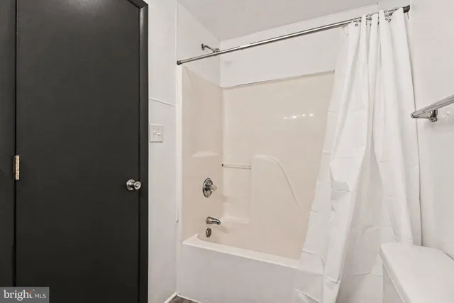 a bathroom with a shower and a bath tub