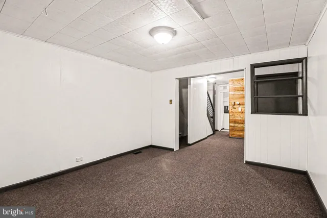 a view of a room with a hallway and stairs