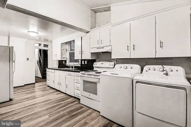 a kitchen with a white cabinets and white appliances