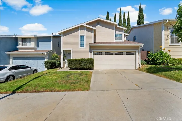 a front view of a house with a garden and plants