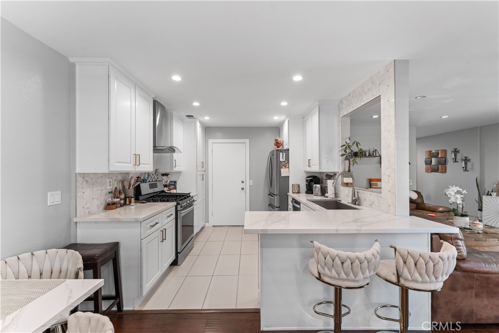 12331 Carl Street Pacoima, CA 91331 - Photo 13 of 28 a kitchen with stainless steel appliances kitchen island granite countertop a sink and cabinets