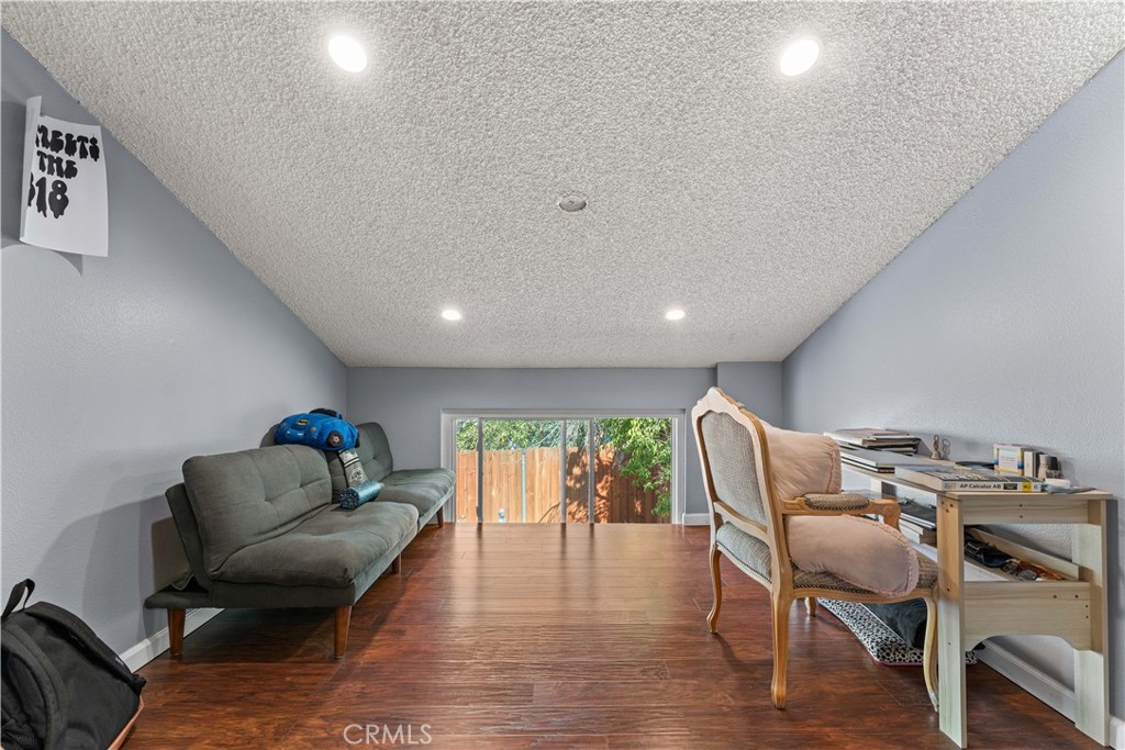 12331 Carl Street Pacoima, CA 91331 - Photo 17 of 28 a living room with furniture and a wooden floor