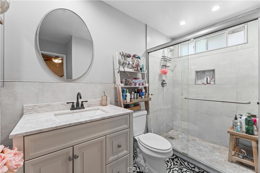 12331 Carl Street Pacoima, CA 91331 - Photo 20 of 28 a bathroom with a sink a toilet and a mirror