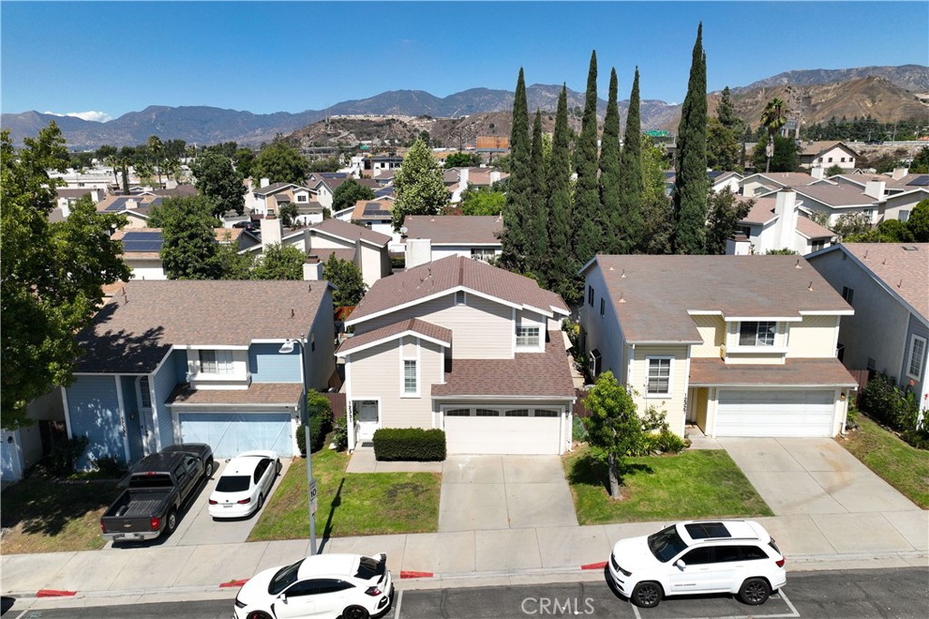 12331 Carl Street Pacoima, CA 91331 - Photo 2 of 28 a car parked in front of a house with a yard