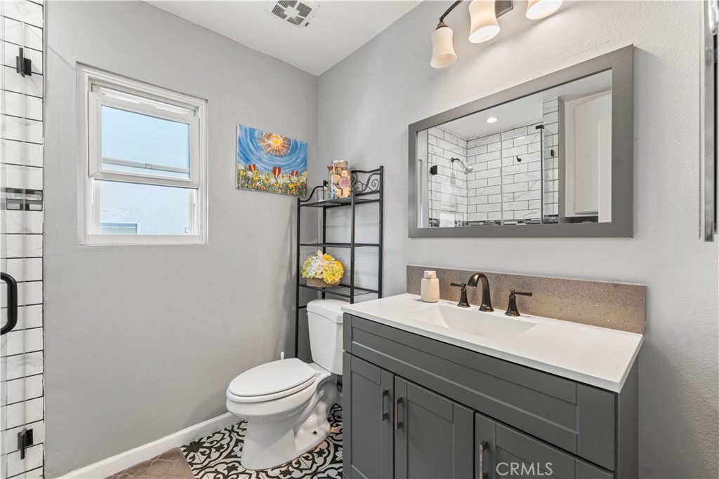 12331 Carl Street Pacoima, CA 91331 - Photo 23 of 28 a bathroom with a sink toilet and mirror