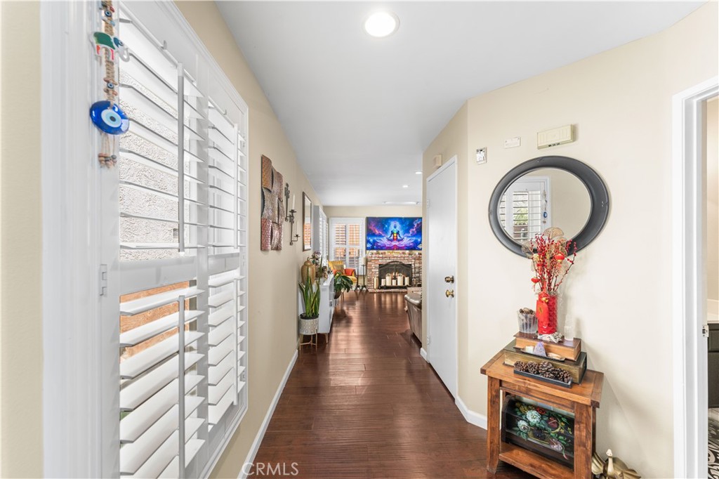 12331 Carl Street Pacoima, CA 91331 - Photo 3 of 28 a view of a hallway with wooden floor and entryway