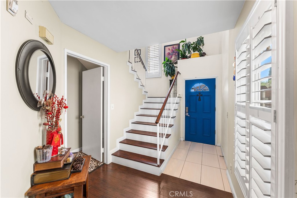 12331 Carl Street Pacoima, CA 91331 - Photo 4 of 28 a view of a hallway with wooden floor and entryway