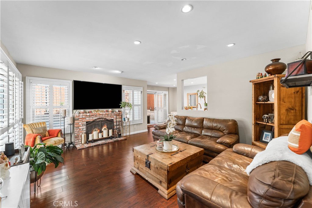 12331 Carl Street Pacoima, CA 91331 - Photo 5 of 28 a living room with furniture flat screen tv and wooden floor