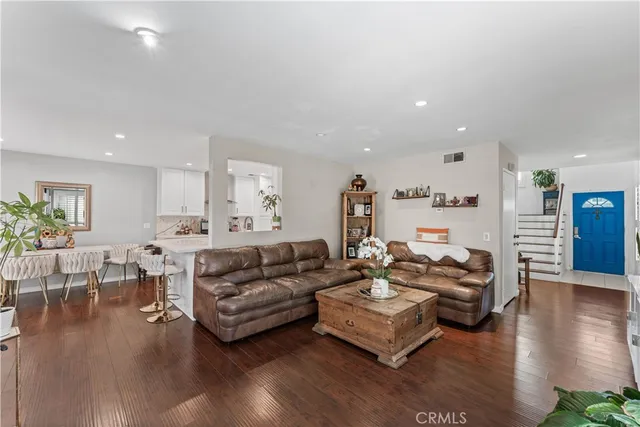 a living room with furniture wooden floor and a table