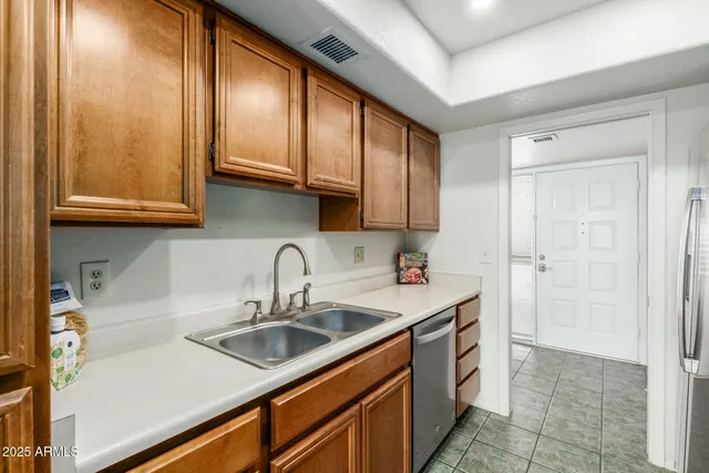 a kitchen with stainless steel appliances granite countertop a sink stove and cabinets