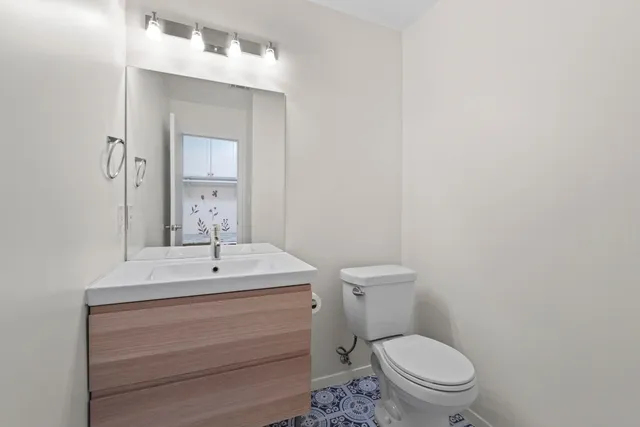 a bathroom with a toilet a sink and mirror
