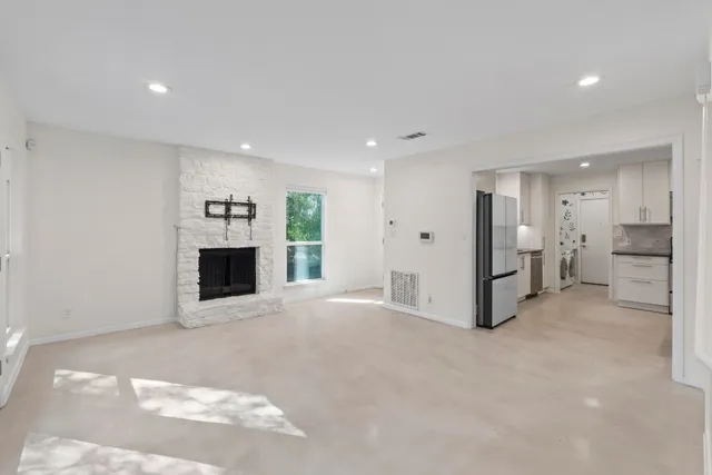 a view of an empty room with a fireplace