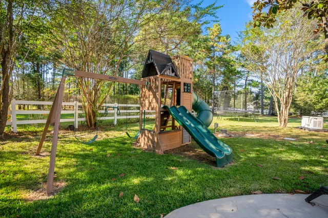a front view of a house with garden and sitting area