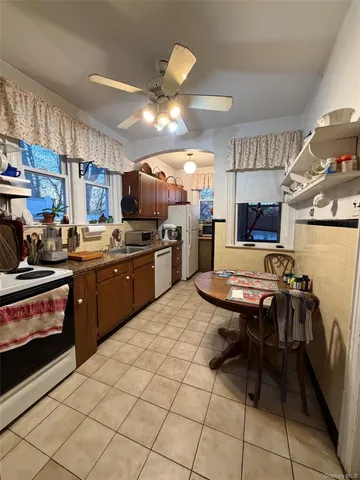 a kitchen with a sink appliances and cabinets