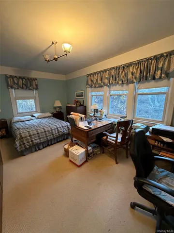 a bedroom with furniture and a large window