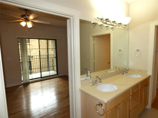 a bathroom with a double vanity sink and a mirror