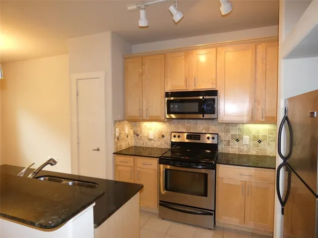 a kitchen with a sink a stove and refrigerator